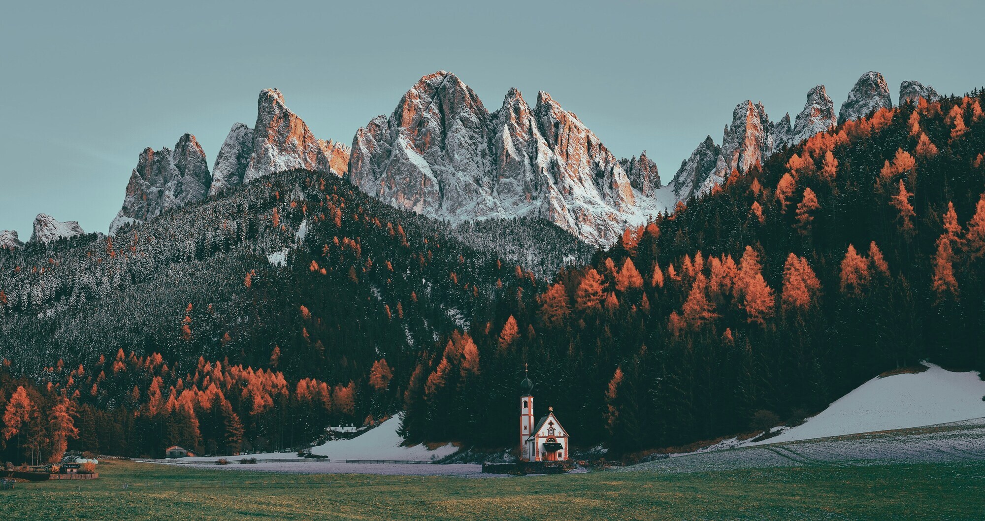 Church in front of a forest and mountains