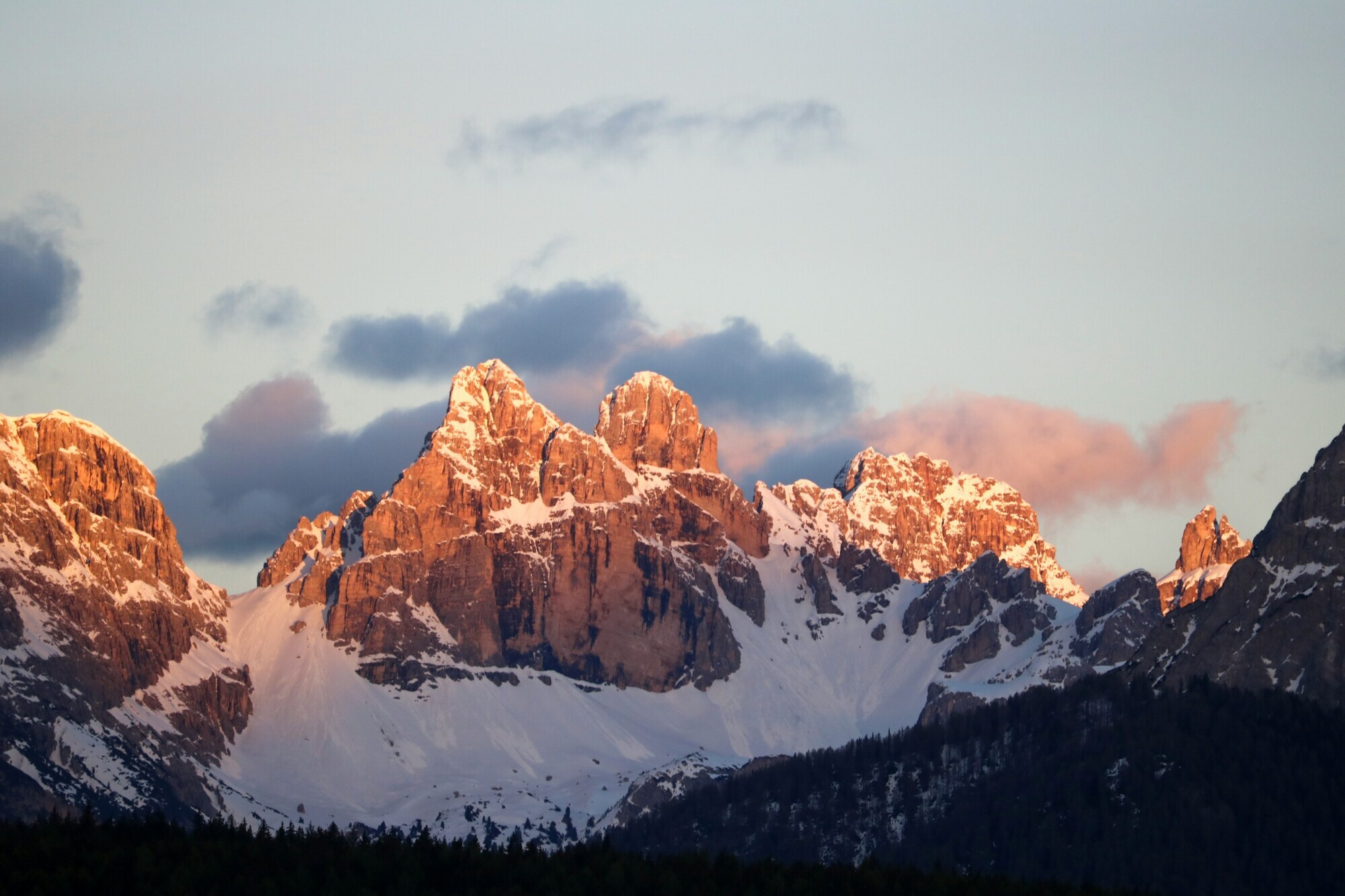 Partly snow-covered rock face, illuminated by the sun