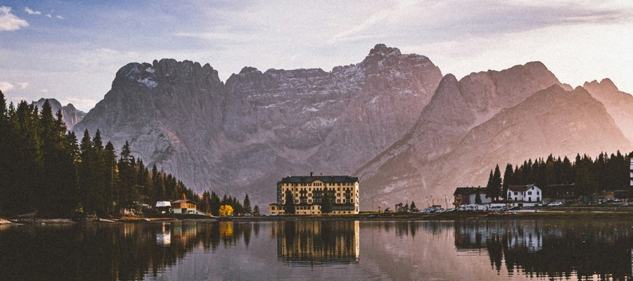 Houses and mountains reflected in a mountain lake