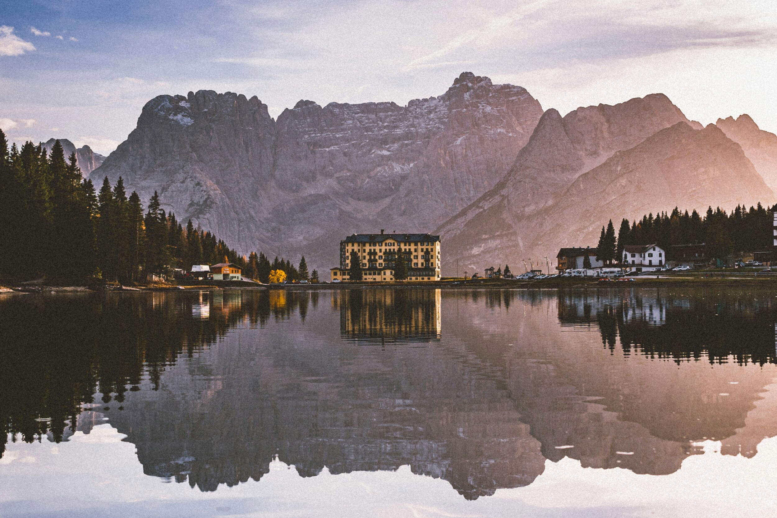 Houses and mountains reflected in a mountain lake