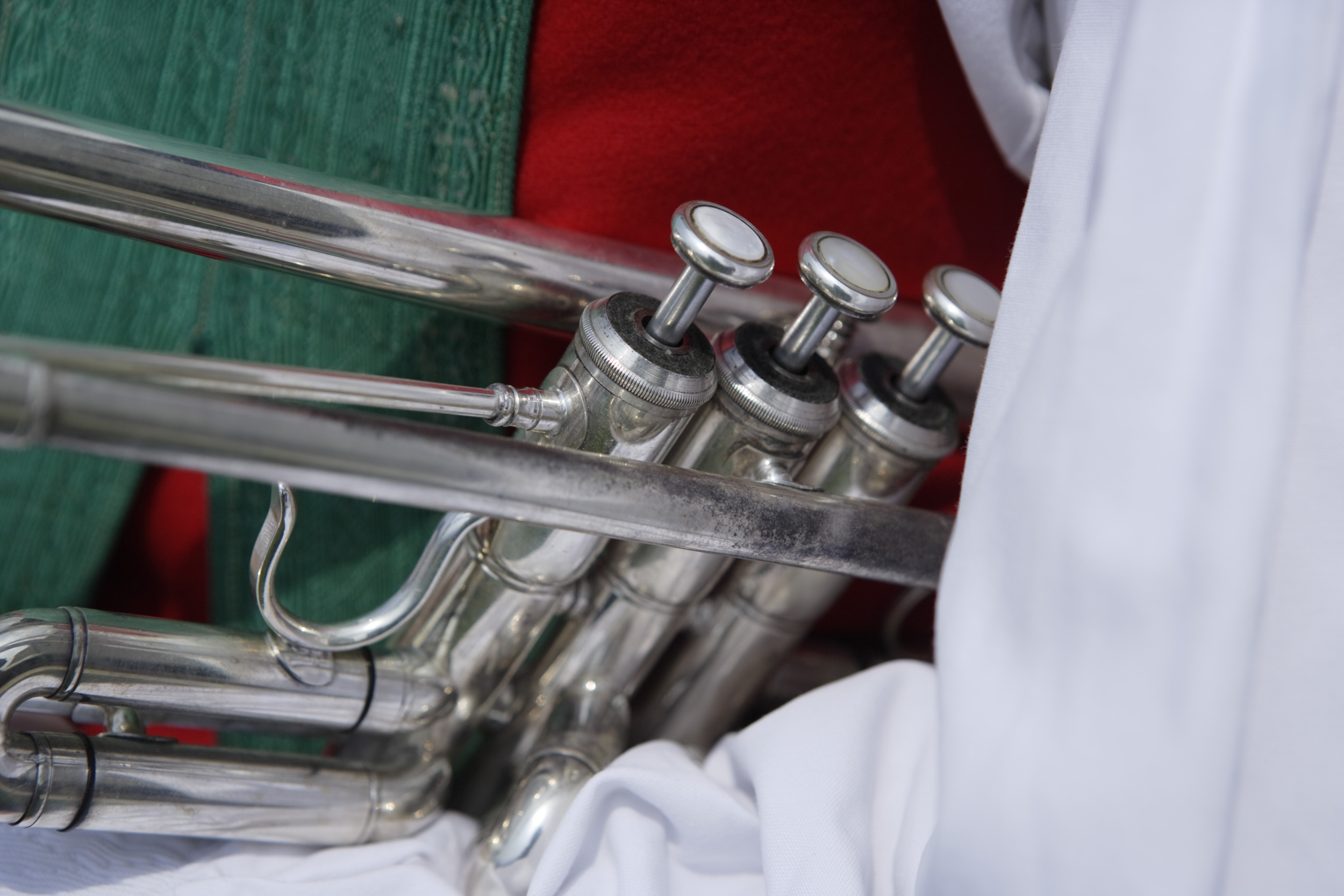 Musical instrument with 3 keys held by a man in traditional costume