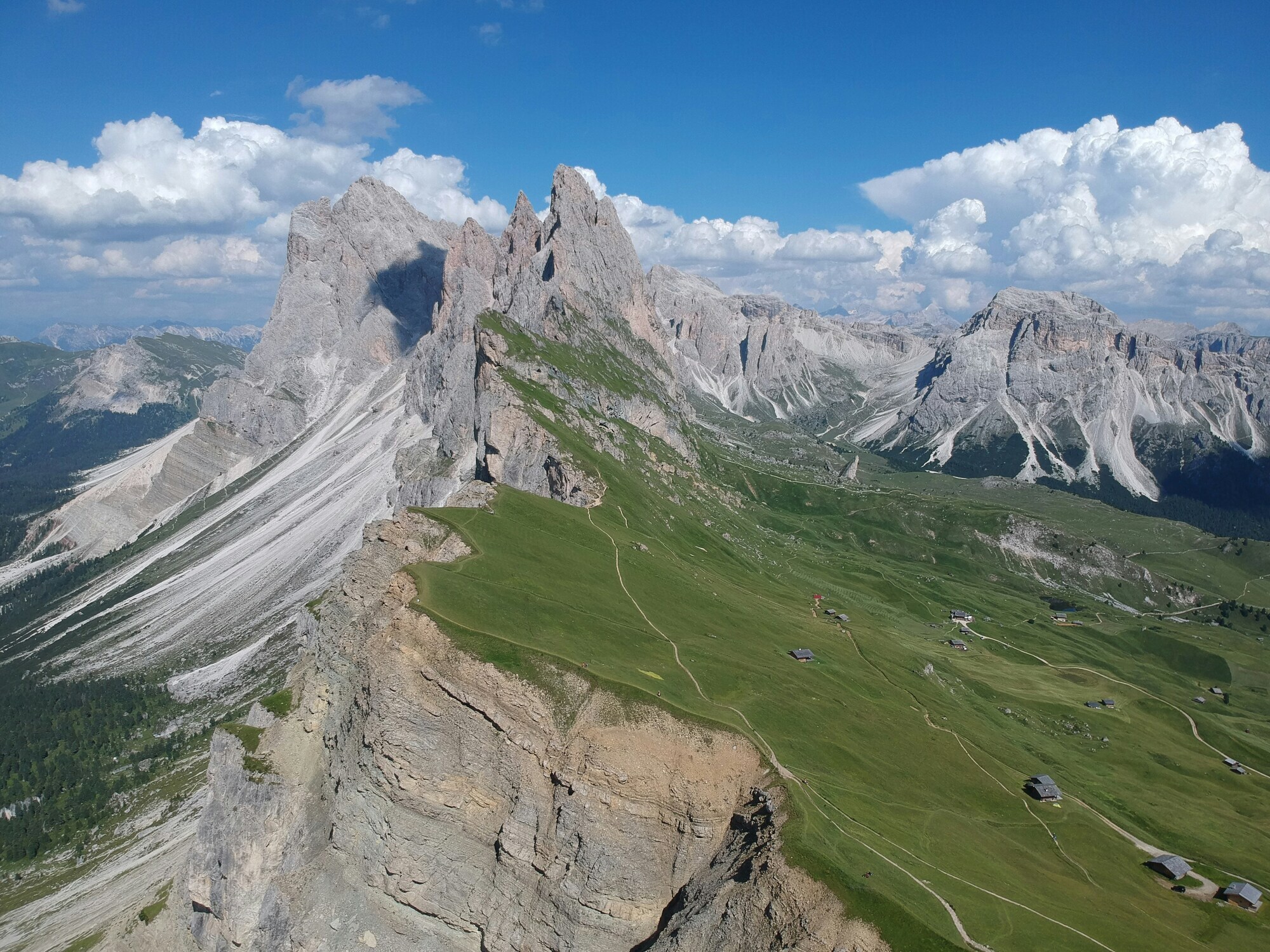 Meadows and hiking trails on the slopes of rugged mountains