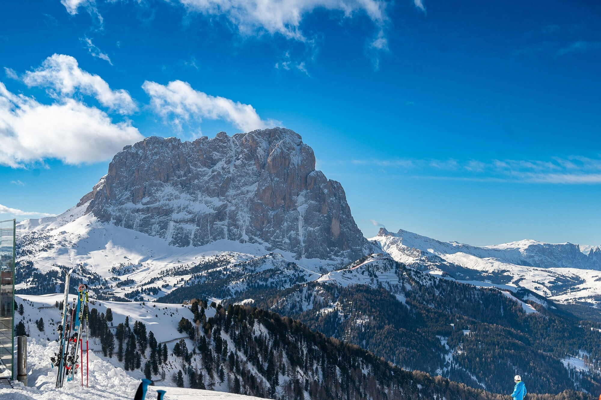 Skis on a slope in front of a stand-alone peak