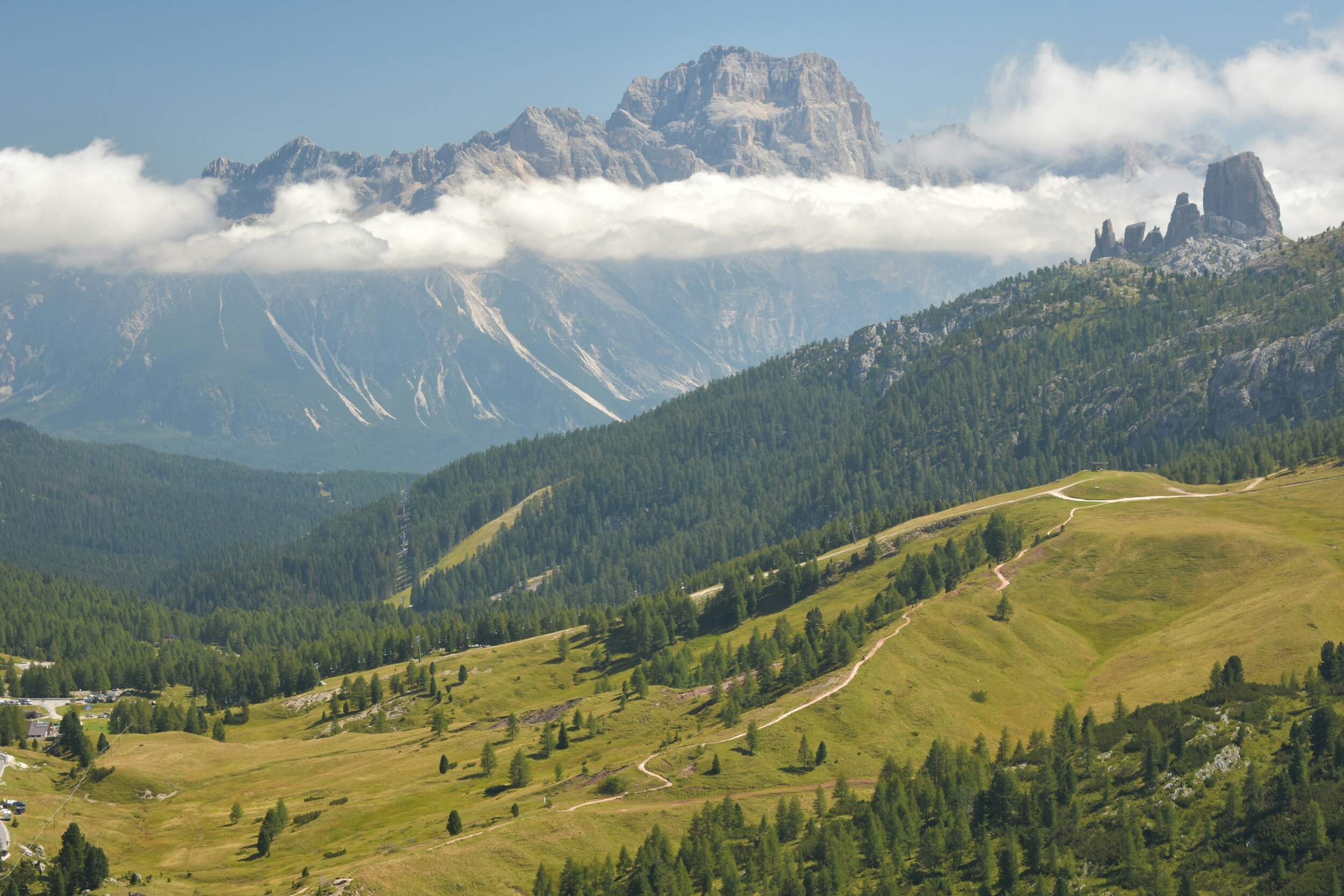 Alpine meadow with hiking trails and Dolomites peaks