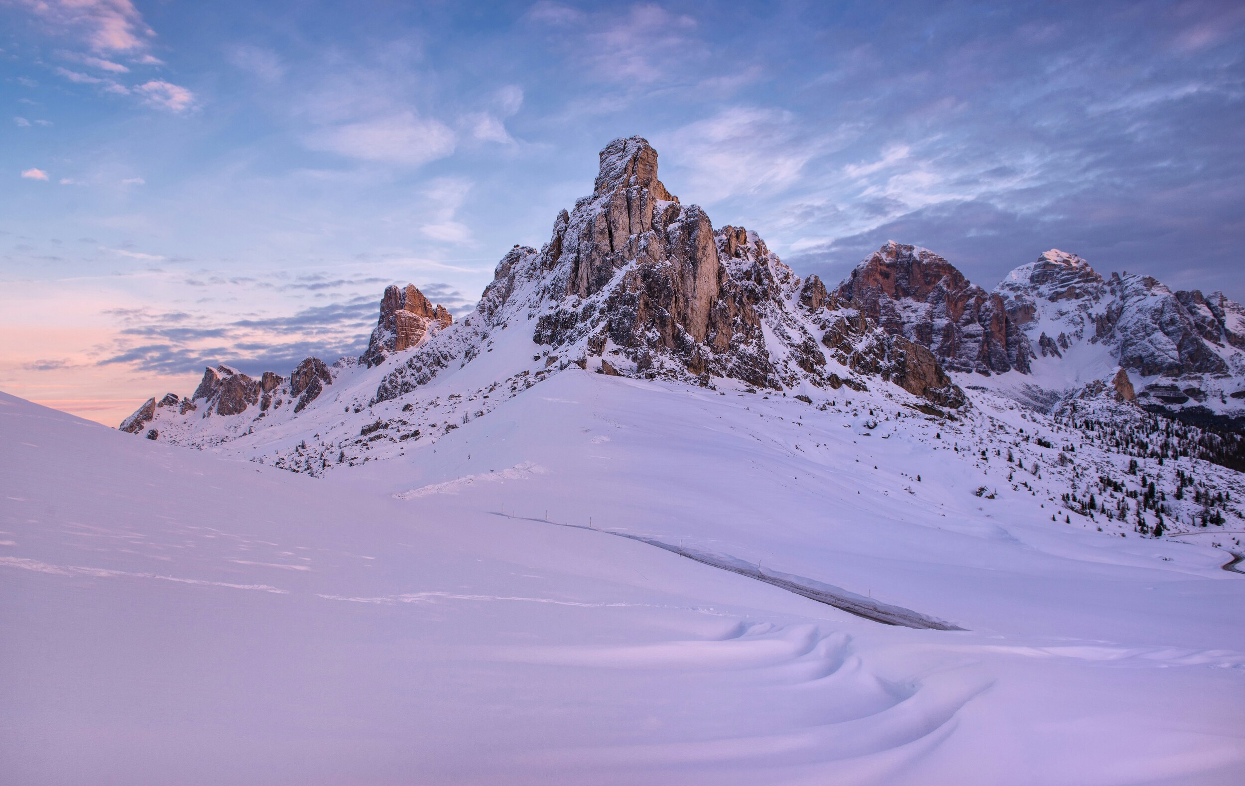 Snowcovered mountain landscape at sunset