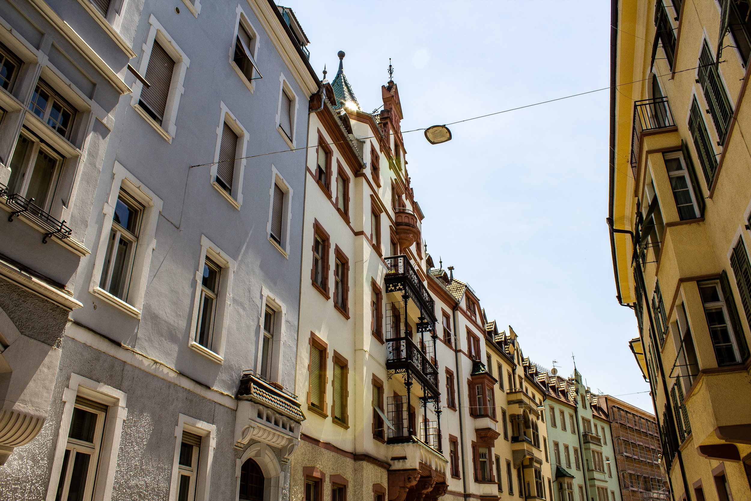 View upwards to colourful house facades on both sides