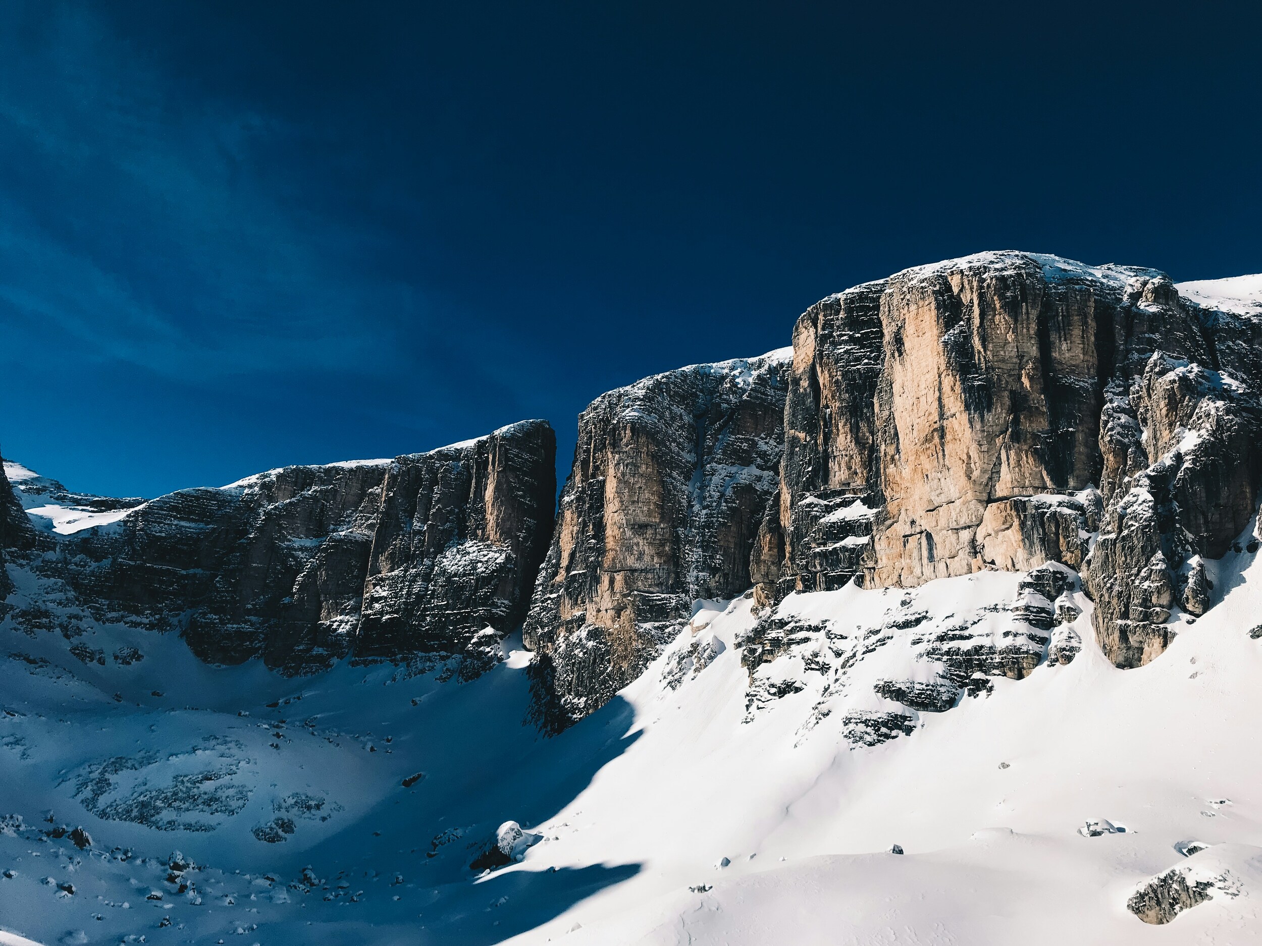 Snow-covered mountain landscape with steep rock walls