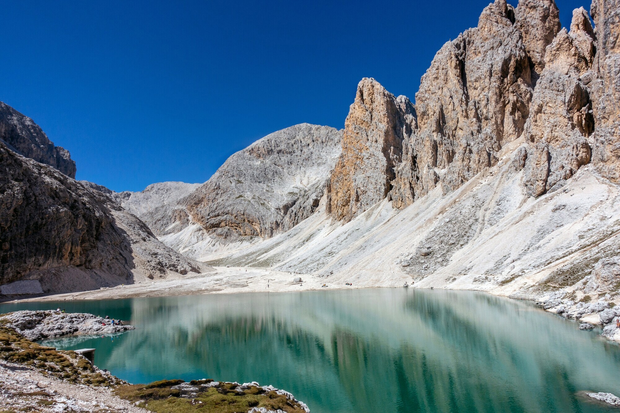 Blue mountain lake surrounded by pale mountains