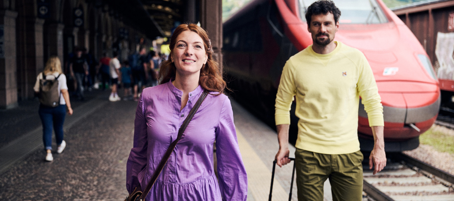 Couple with suitcases at the train station