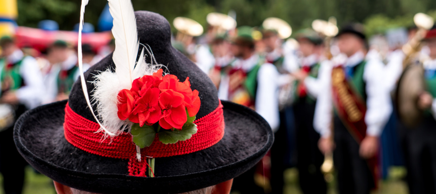 Black and red traditional hat with feather & marching band