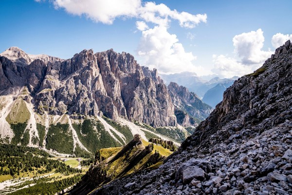 Green valley framed by steep, rugged rock walls