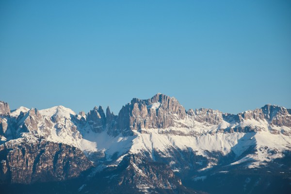 Mountain range covered with snow with blue sky