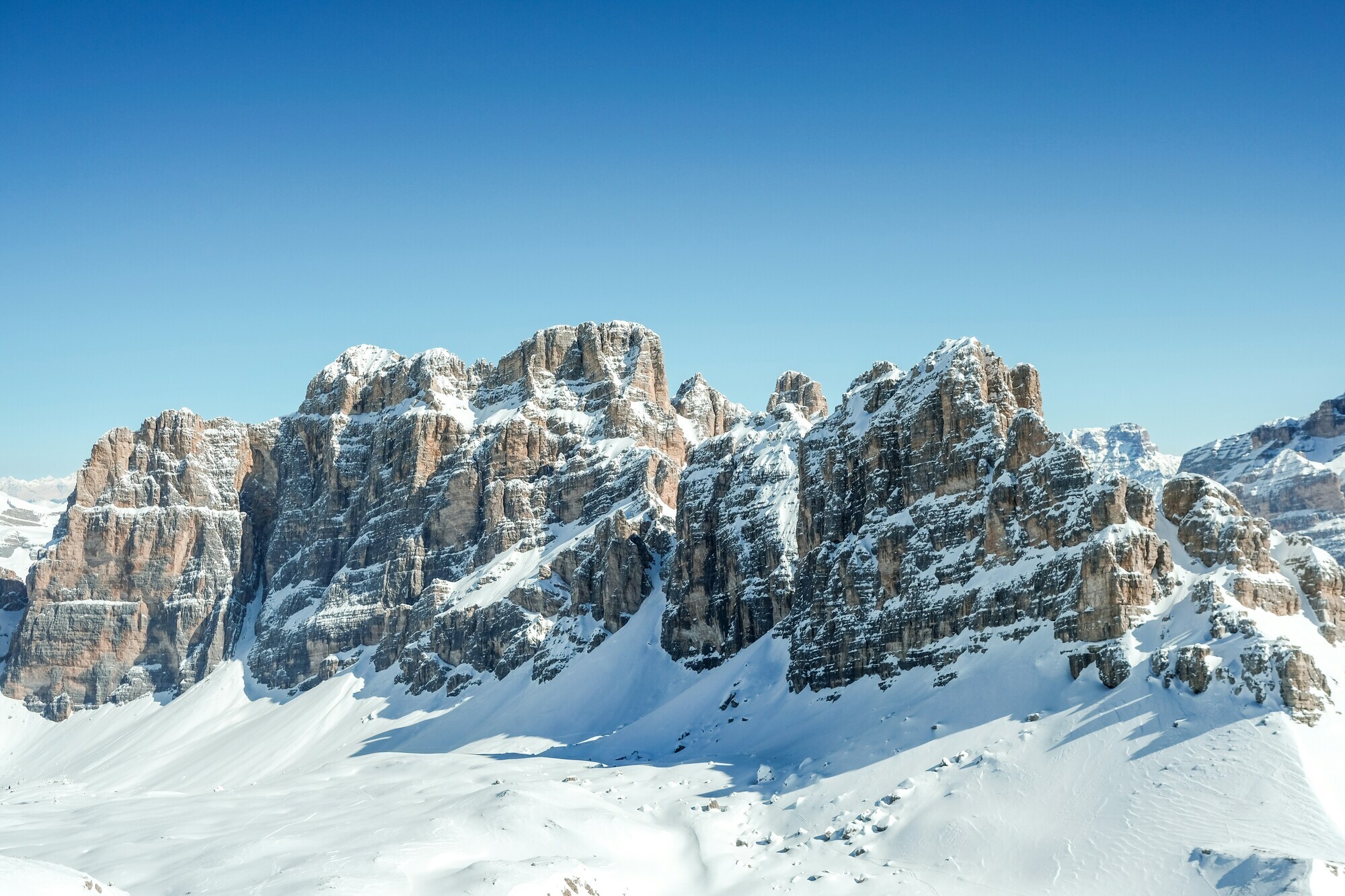 Snow-covered valley with mountains in the background