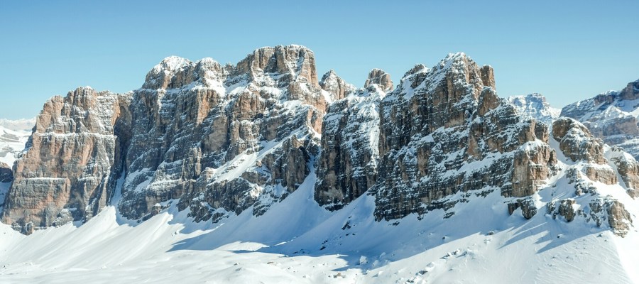 Snow-covered valley with mountains in the background