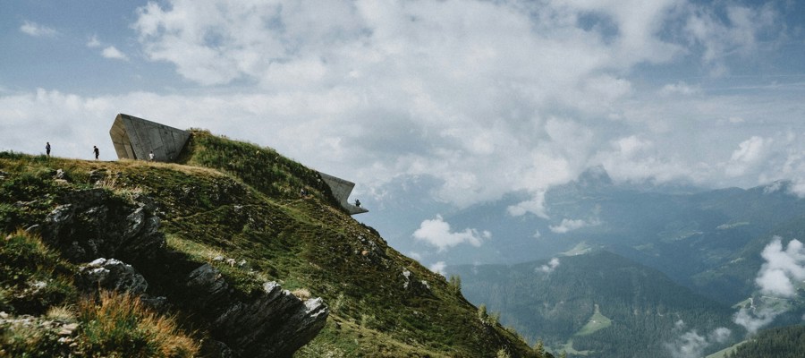 Futuristic concrete building on a mountainside