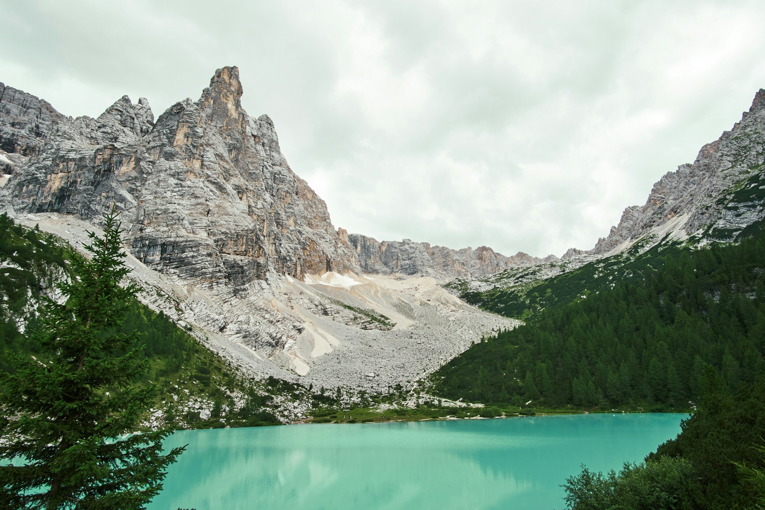 Turquoise mountain lake framed by trees and mountains