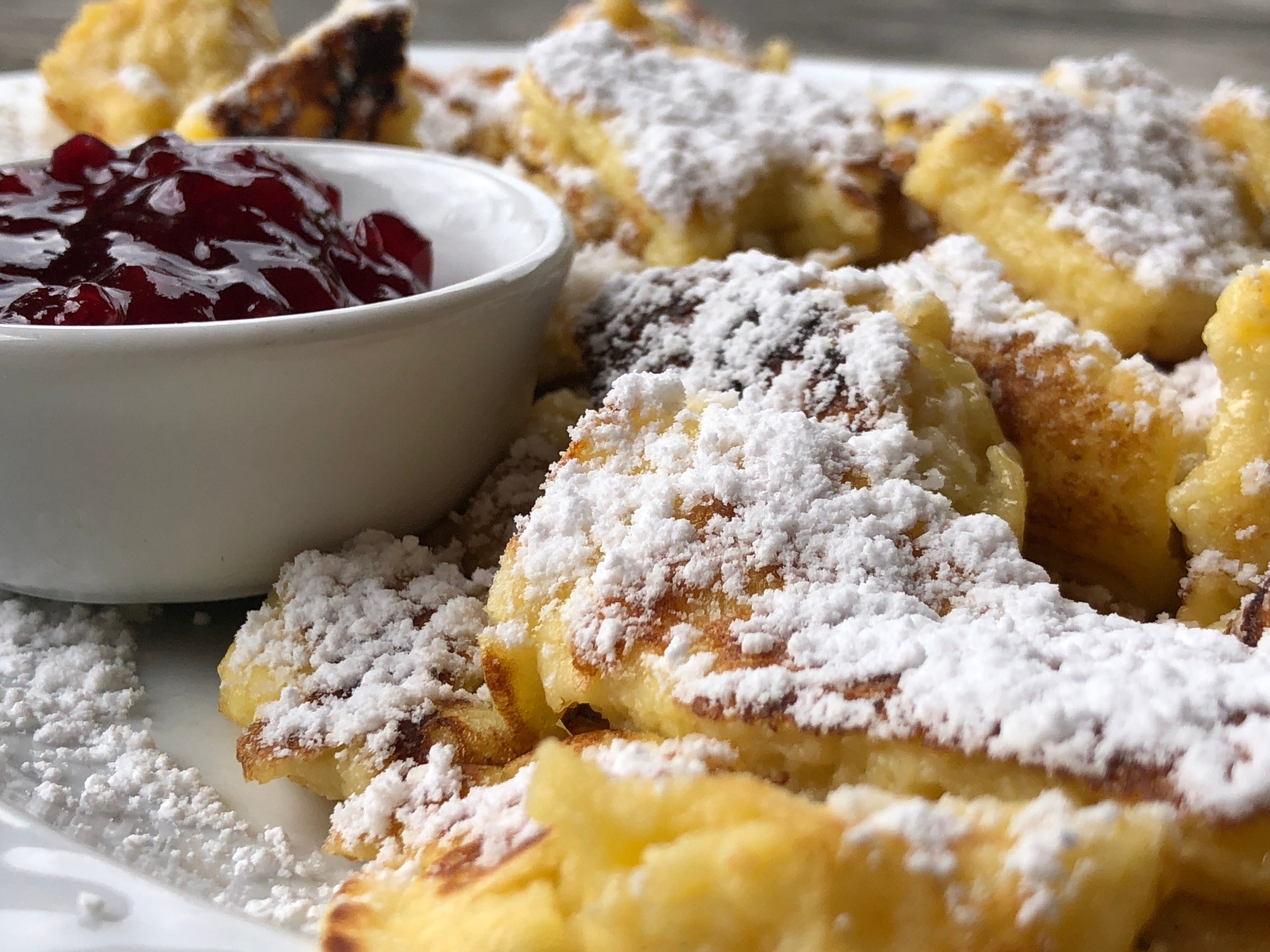 Kaiserschmarrn with icing sugar and cranberry jam