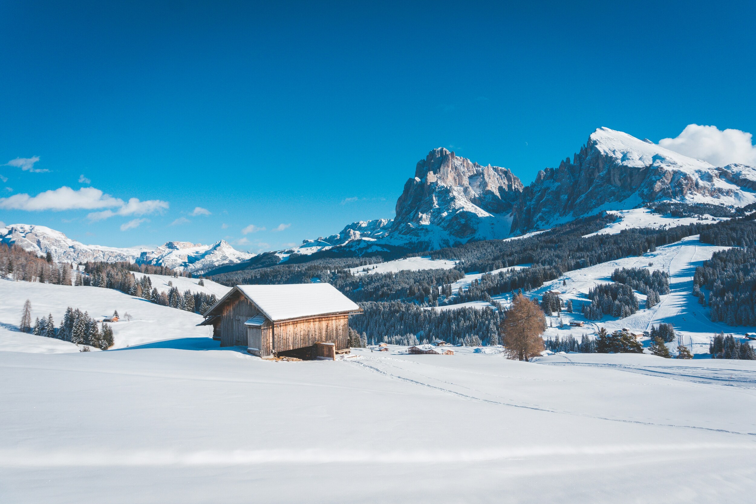 Winter landscape and dolomites against a blue sky