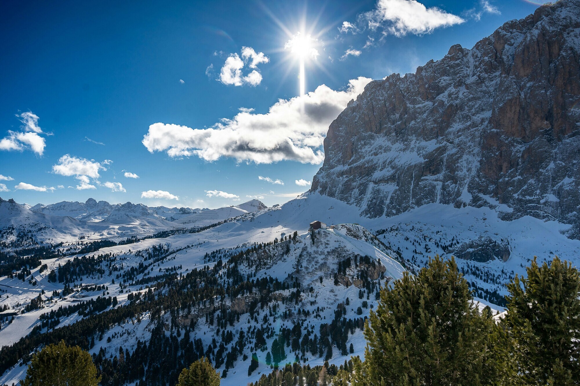 Winter mountain landscape with shining sun in a blue sky