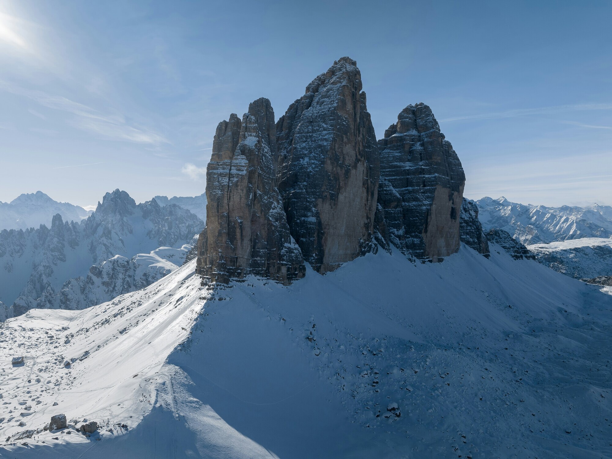 Winter landscape with three free-standing peaks and blue sky