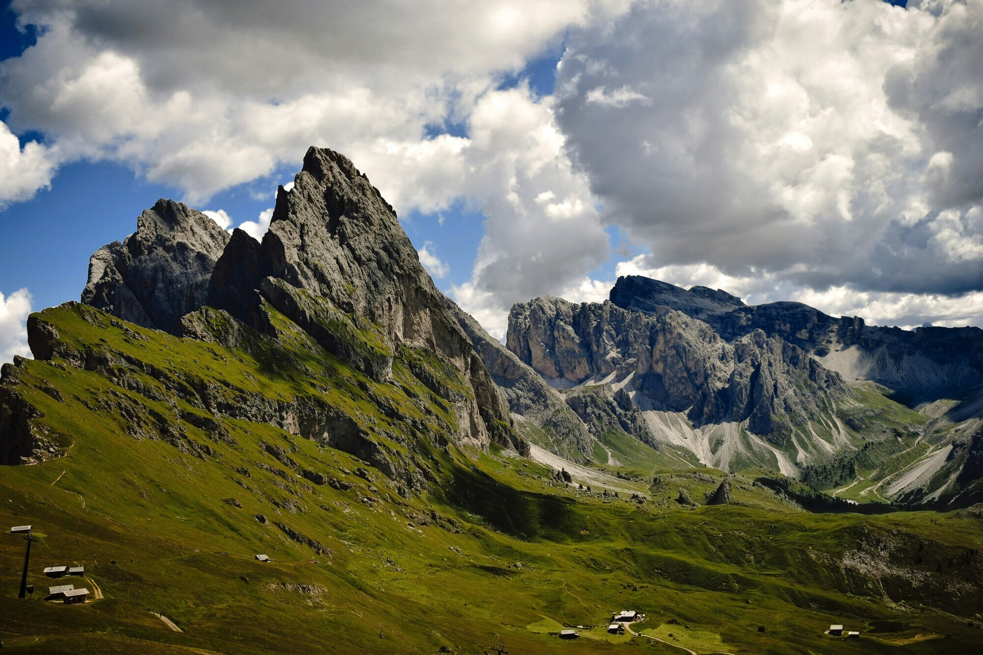 Green meadows and rugged Dolomites peaks