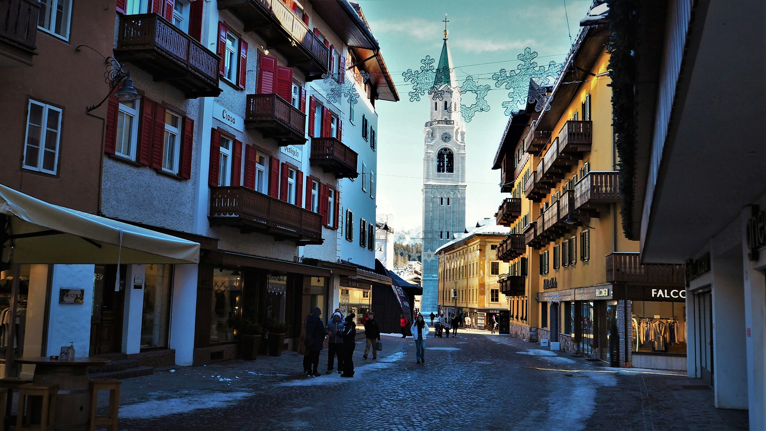 Church and houses framing a street in Cortina d'Ampezzo