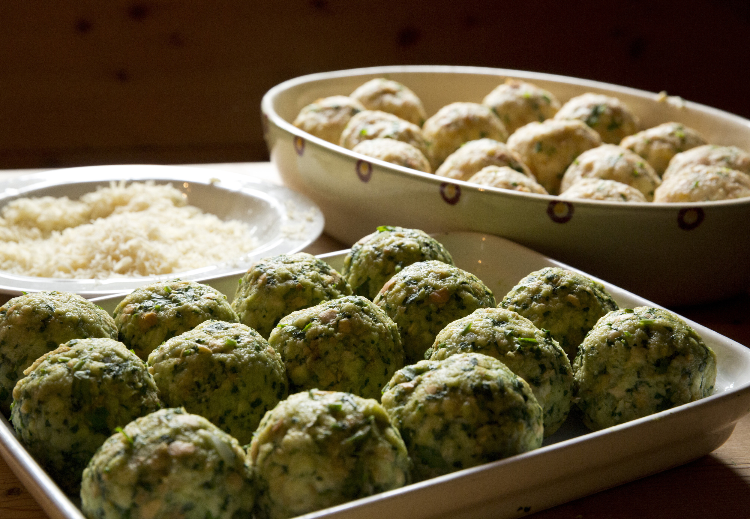 Spinach & bacon dumplings served with parmesan in traditional serving bowls