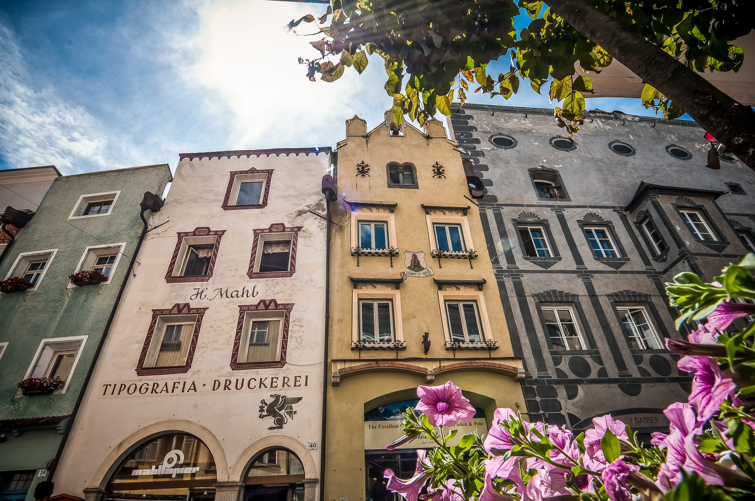 View upwards to different coloured facades of historic townhouses