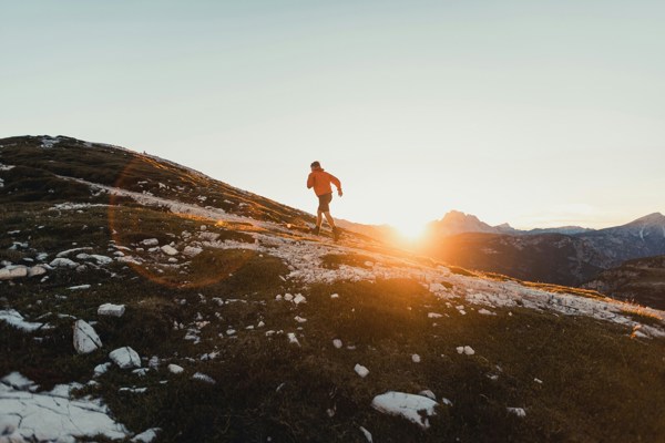 Hiker on a hiking trail at sunrise