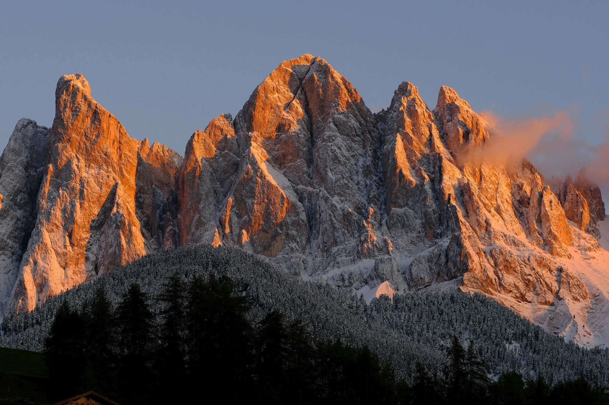 Red-coloured peaks with snow at sunset