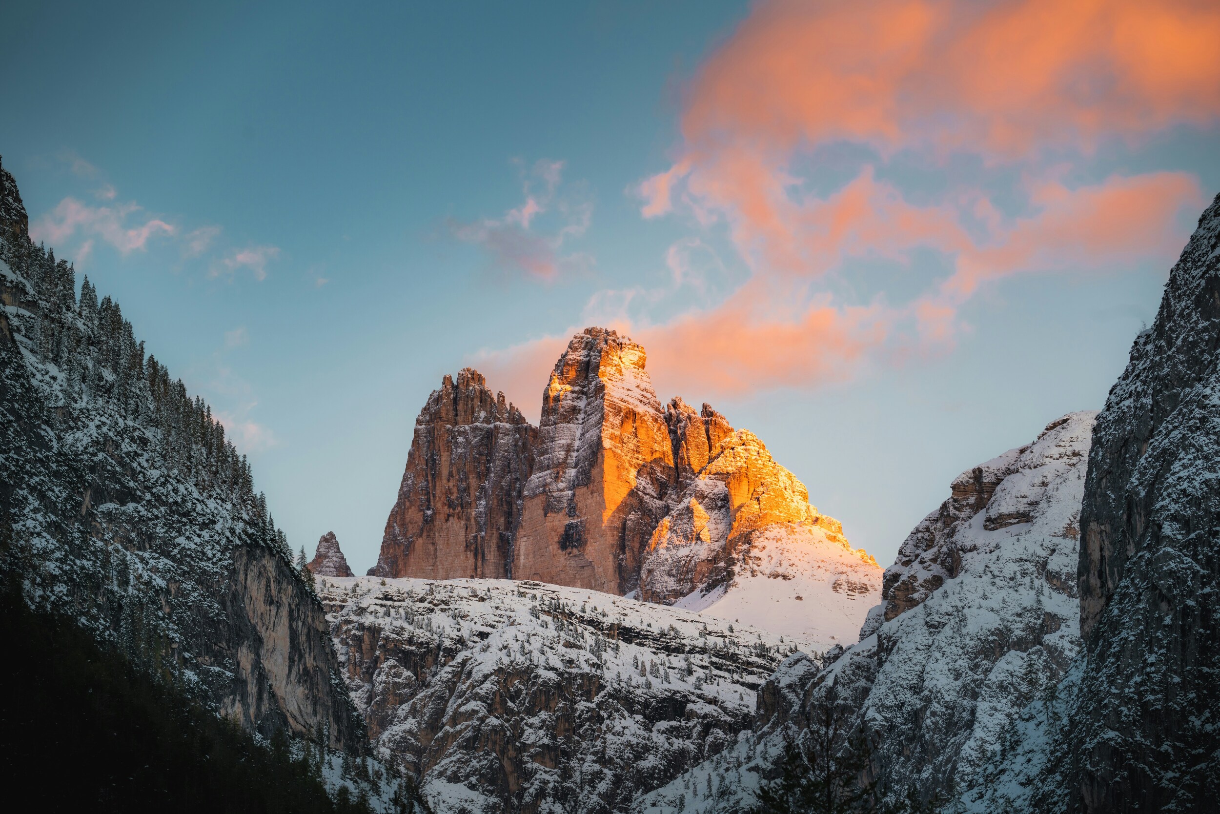 Snow-covered rock faces of the Three Peaks, illuminated by the sun on one side