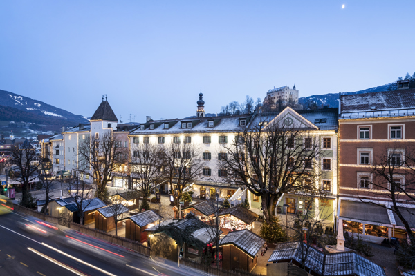 Evening atmosphere over the illuminated wooden huts of a Christmas market