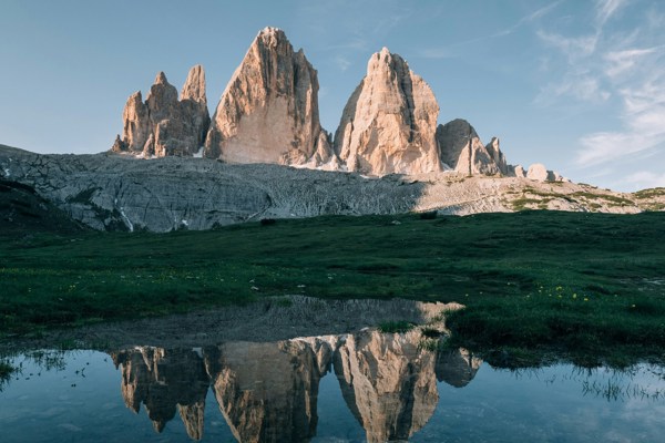 Three peaks reflecting themselves in a small lake