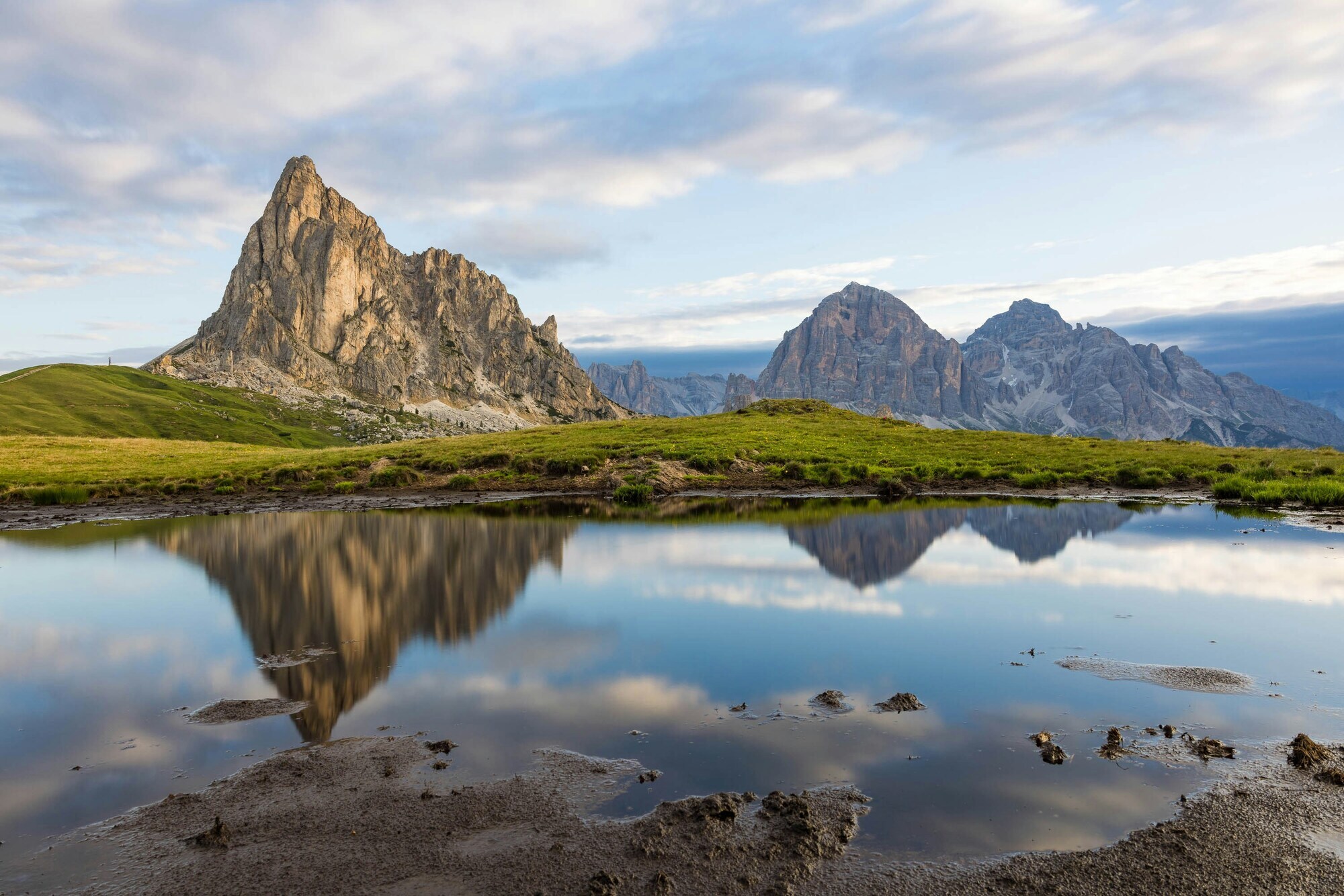 Dolomites mountains reflected in the waters of a small lake