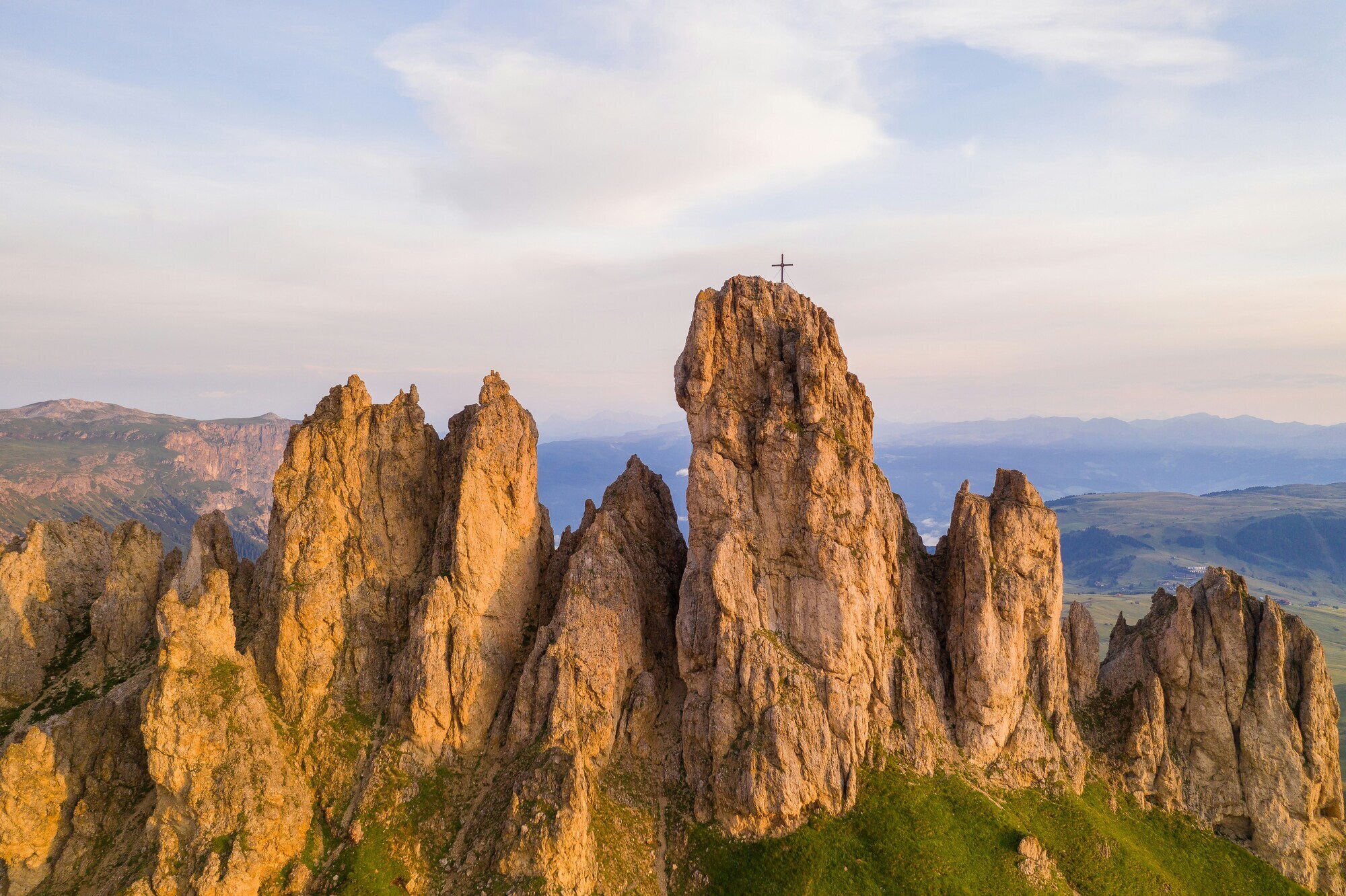 Rocky peaks with summit cross in warm light