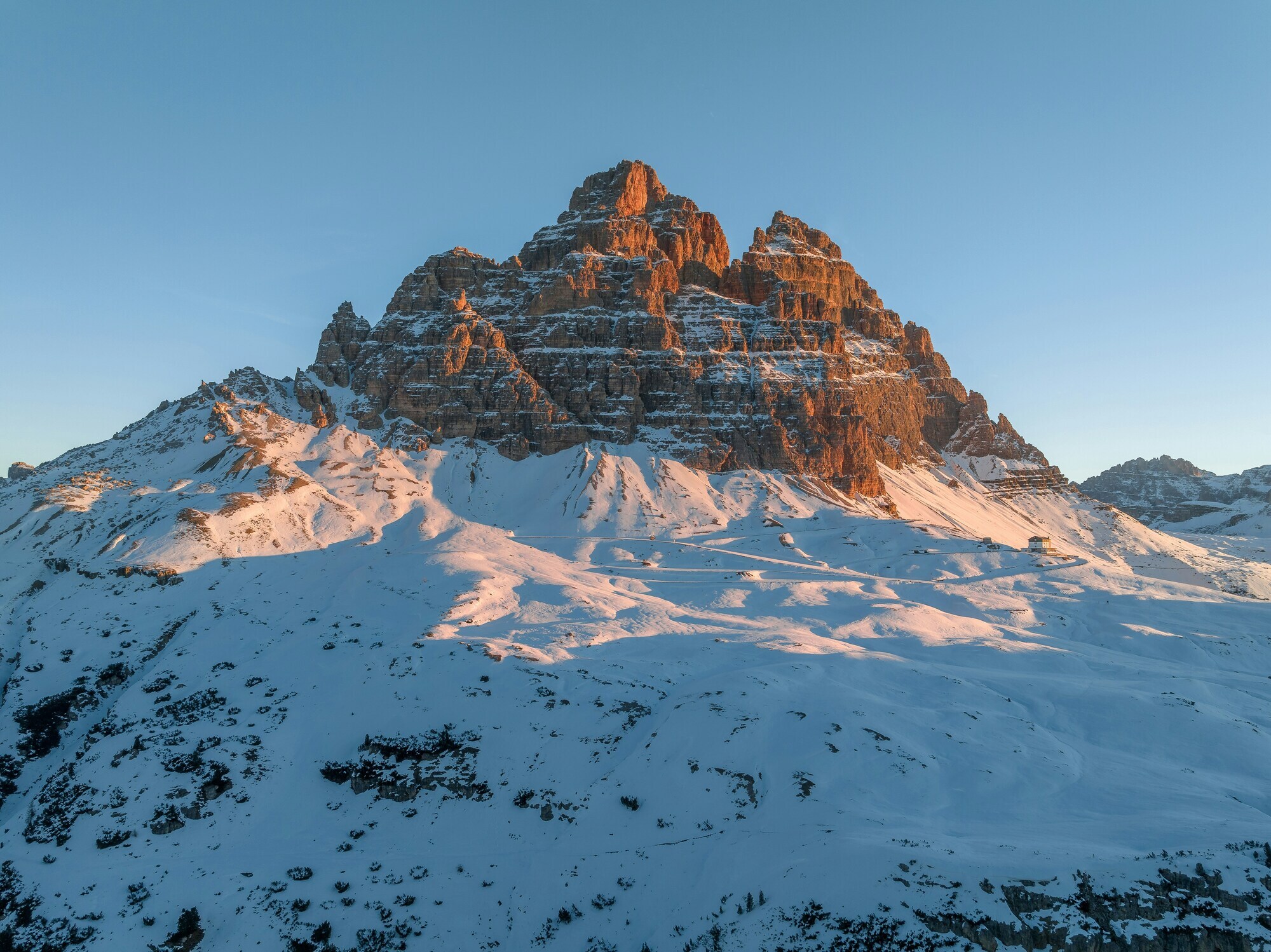 Rugged peaks at sunrise in snow-covered landscape