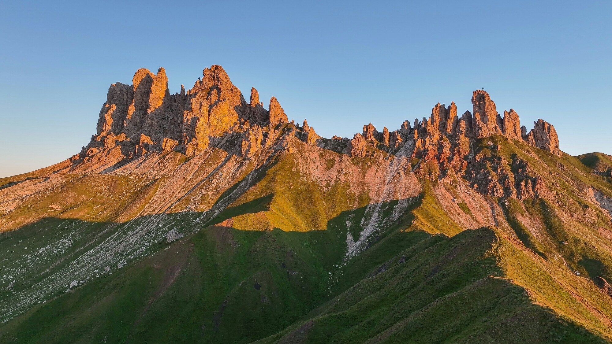 Mountain ridge with many rocky peaks in the light of the setting sun