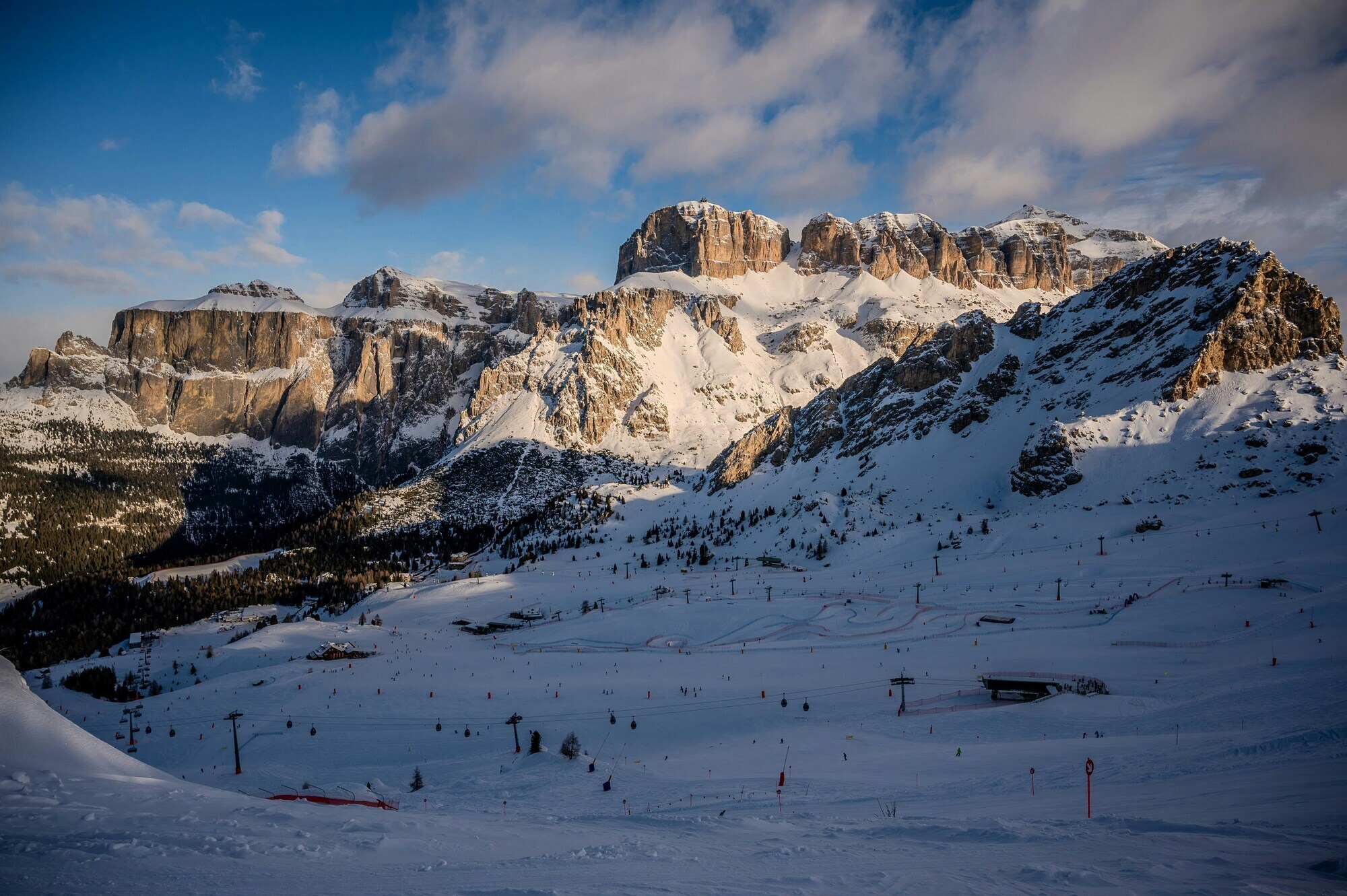 Ski runs and lifts with mountains in the background