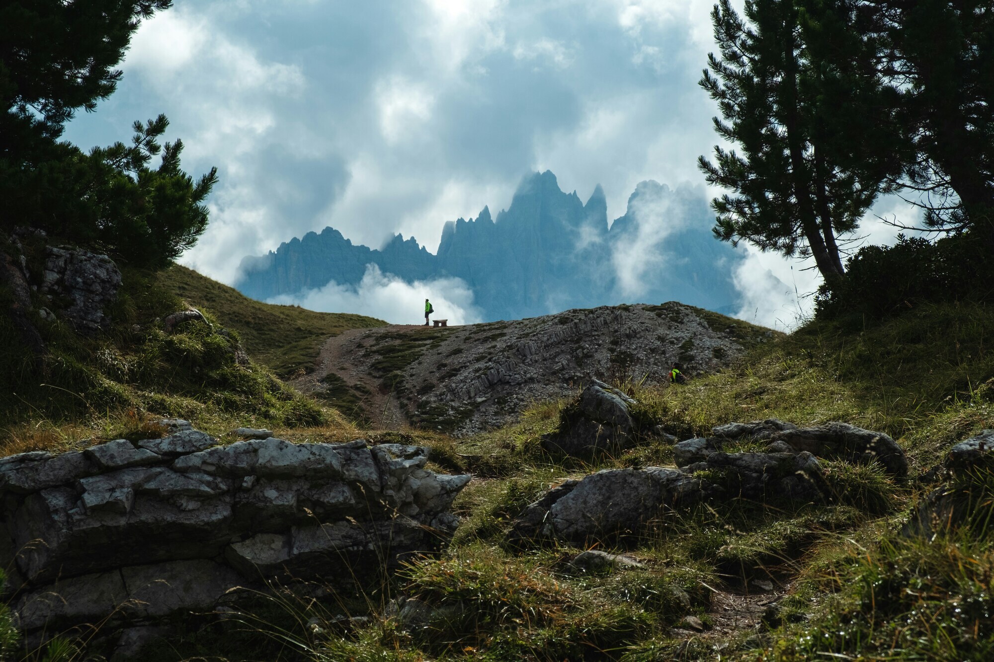 Hiker and a bench in the foggy mountains