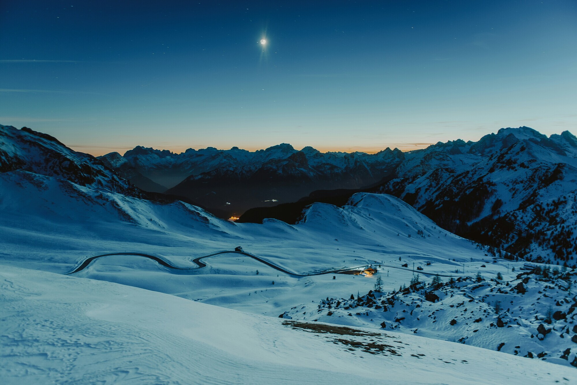 Winding pass road at night under the moonlight in winter