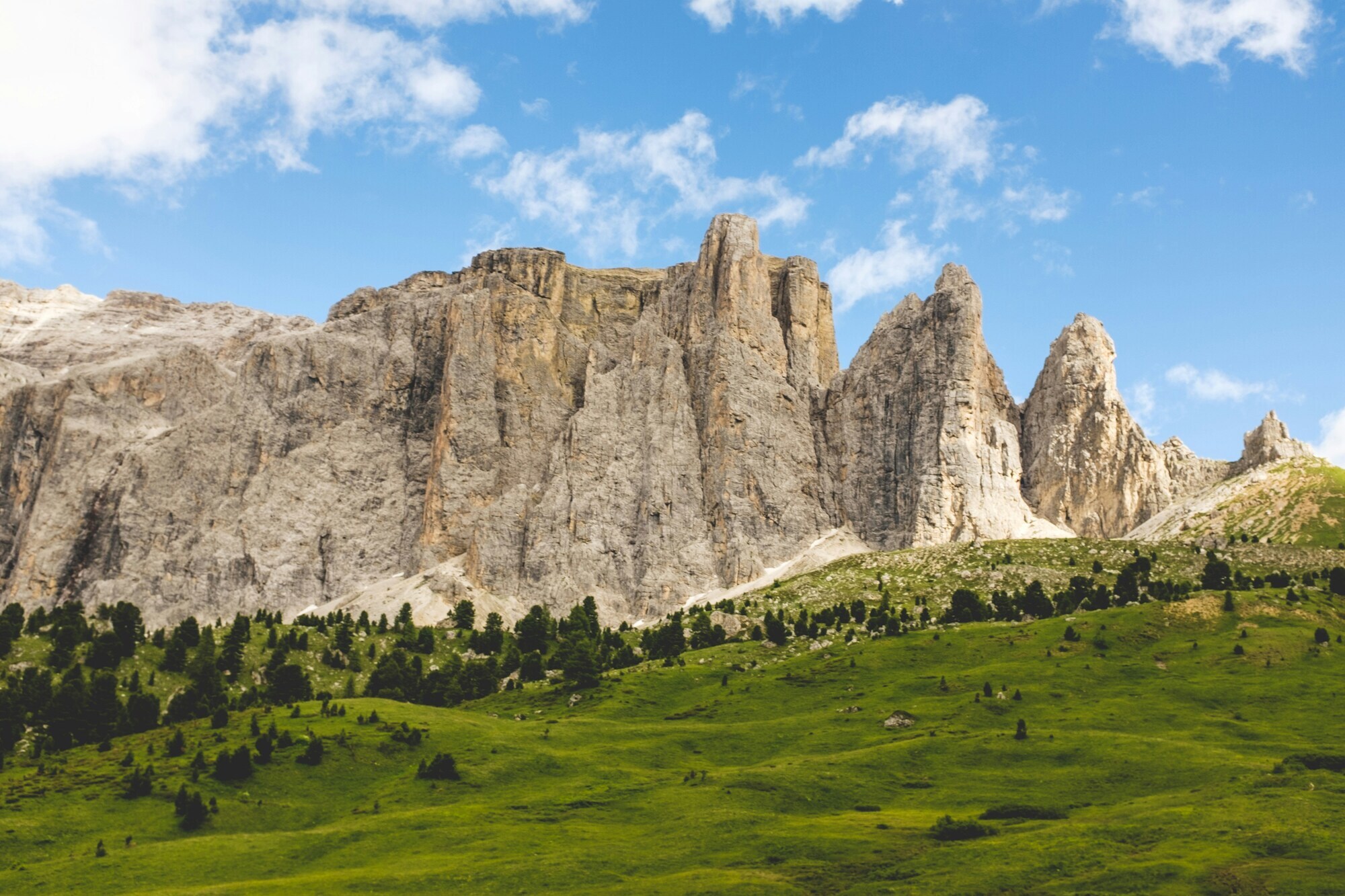 Green meadow with steep rock walls