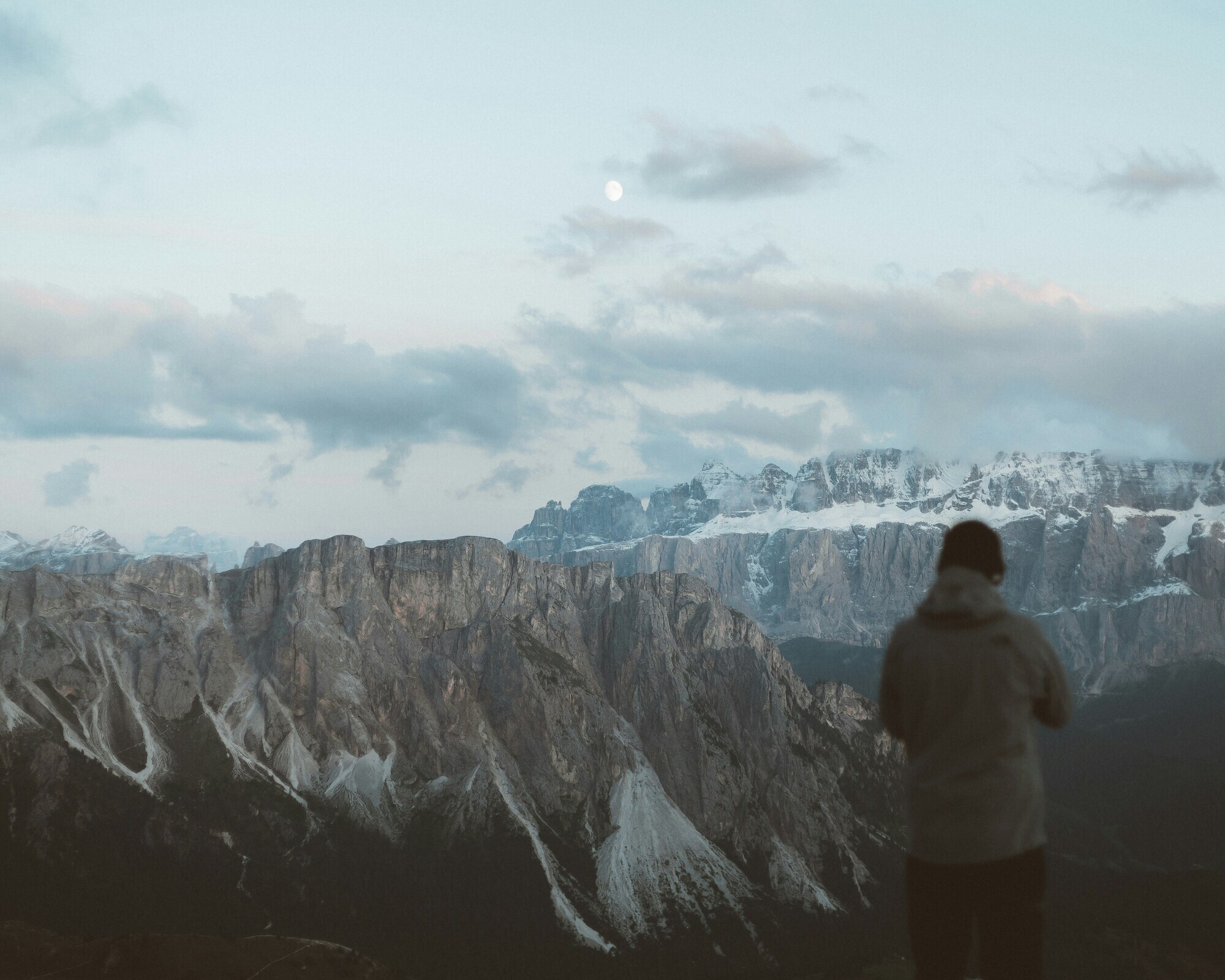 Man standing in front of a winter mountain scenery