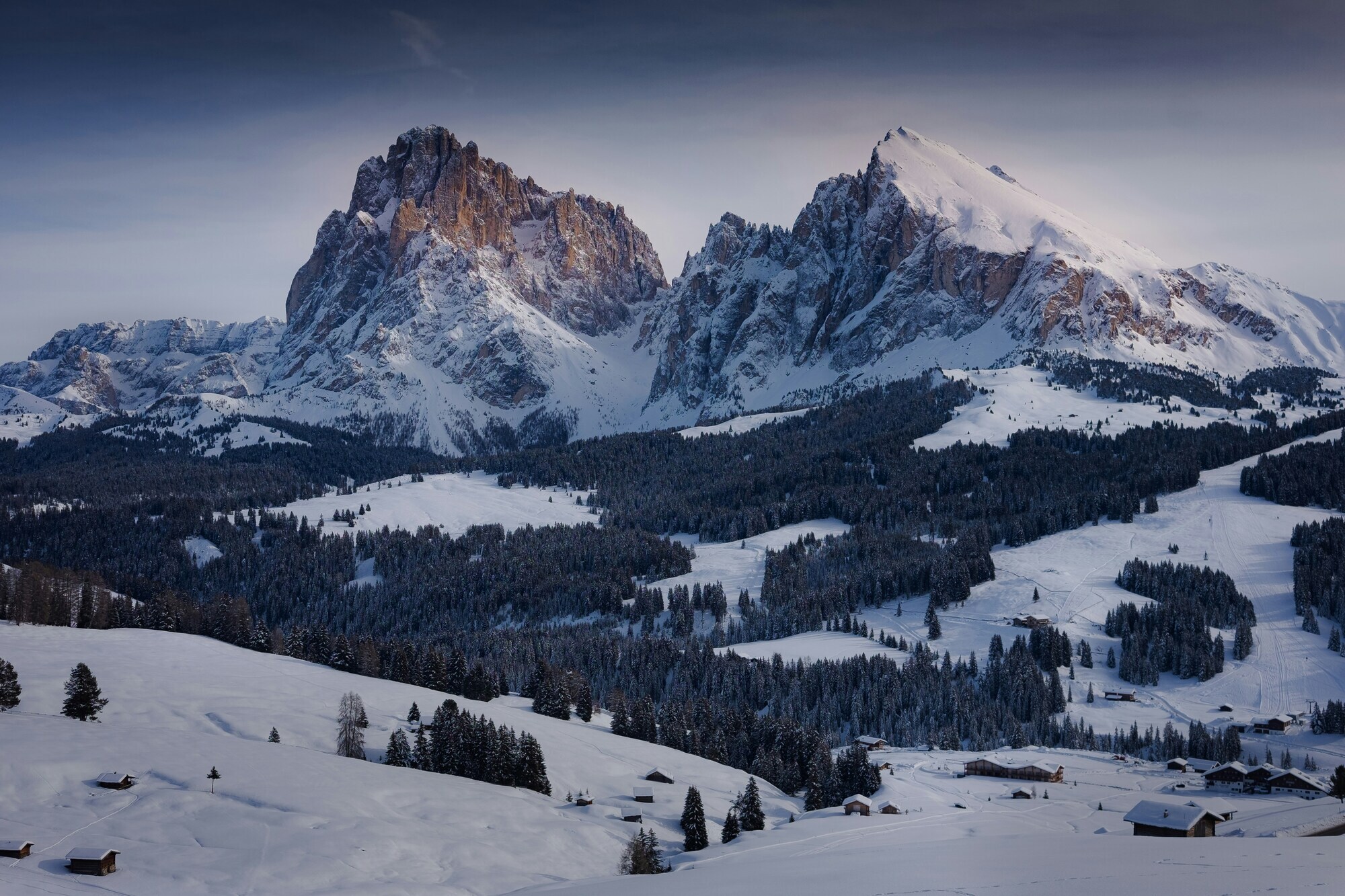 Snow-covered Sassolungo gourp at dusk