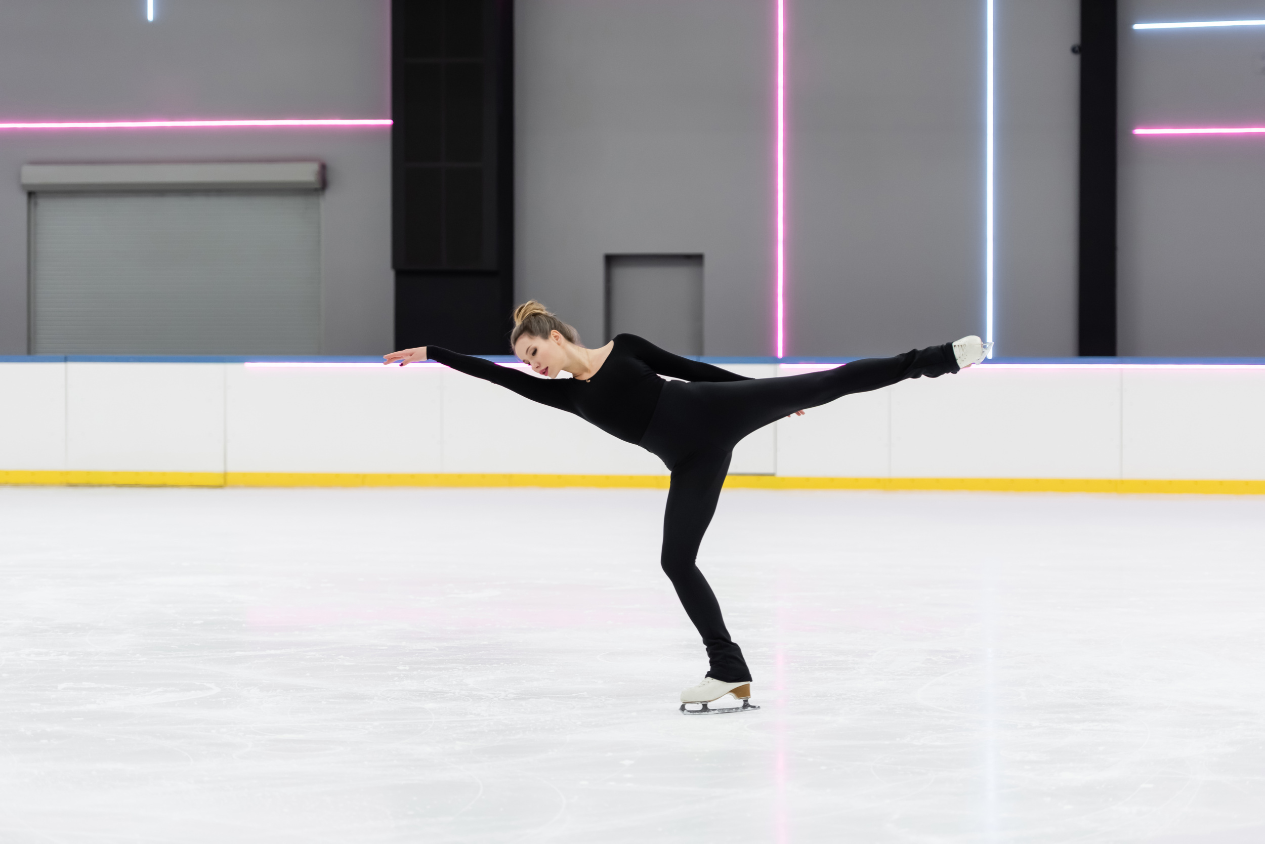 Figure skater in a black suit during training