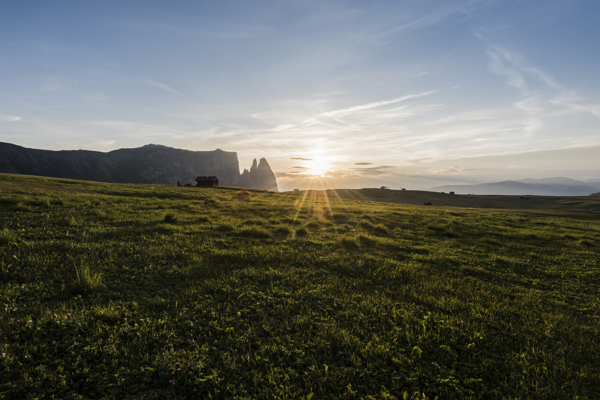 Sunset on an Alpine farm, hut and mountains