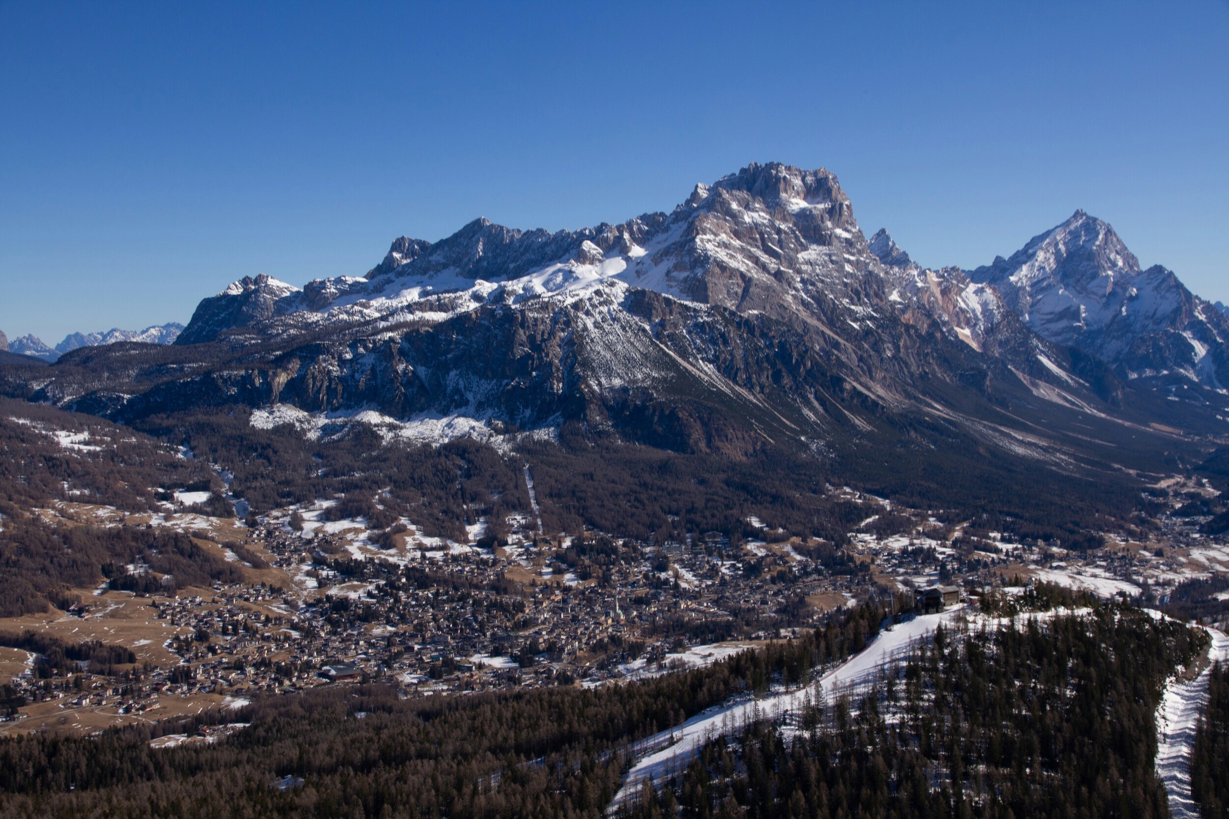 View of Cortina d'Ampezzo in autumn with the high mountains covered in snow