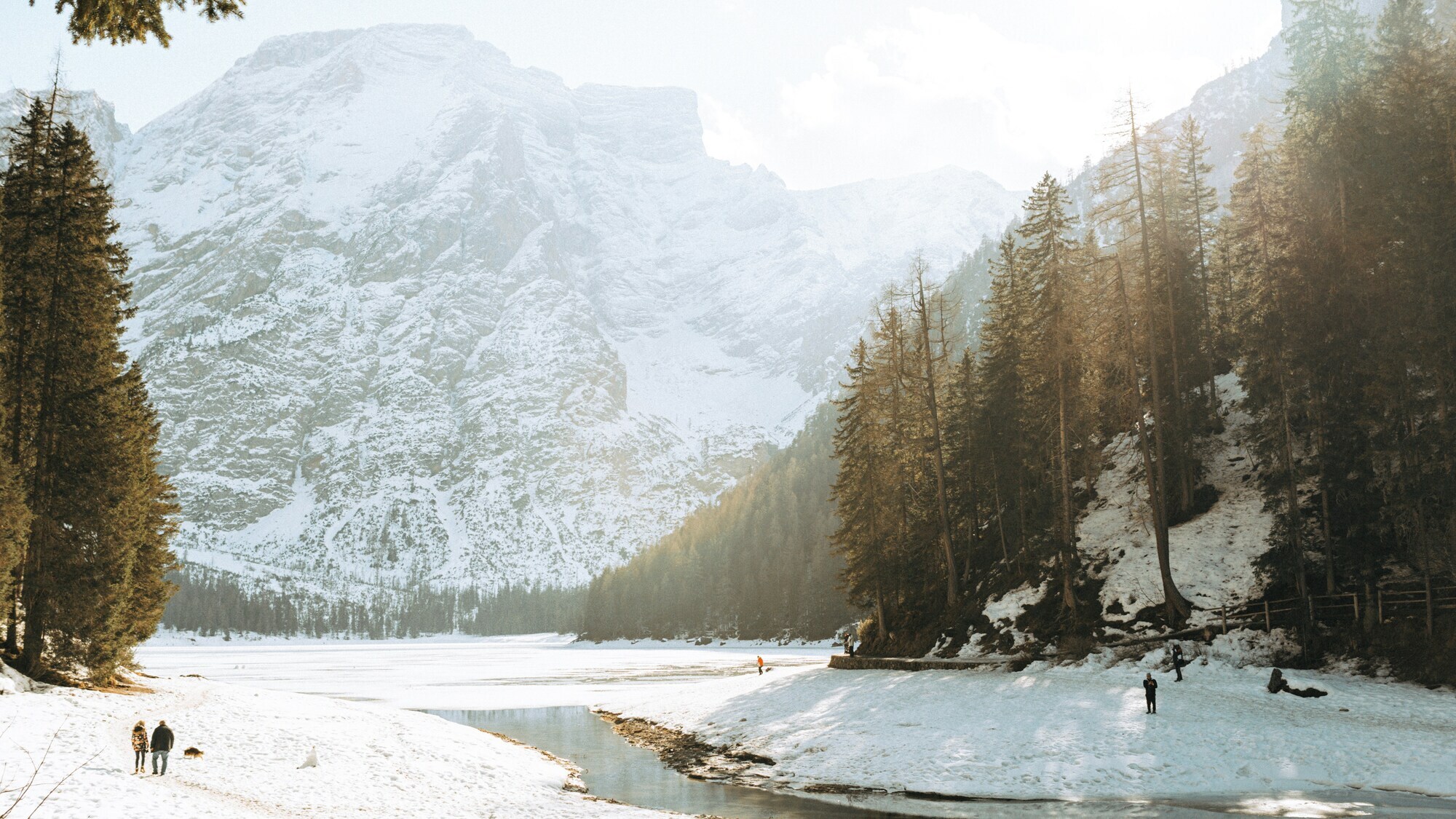 Winter landscape with high rock face and frozen lake