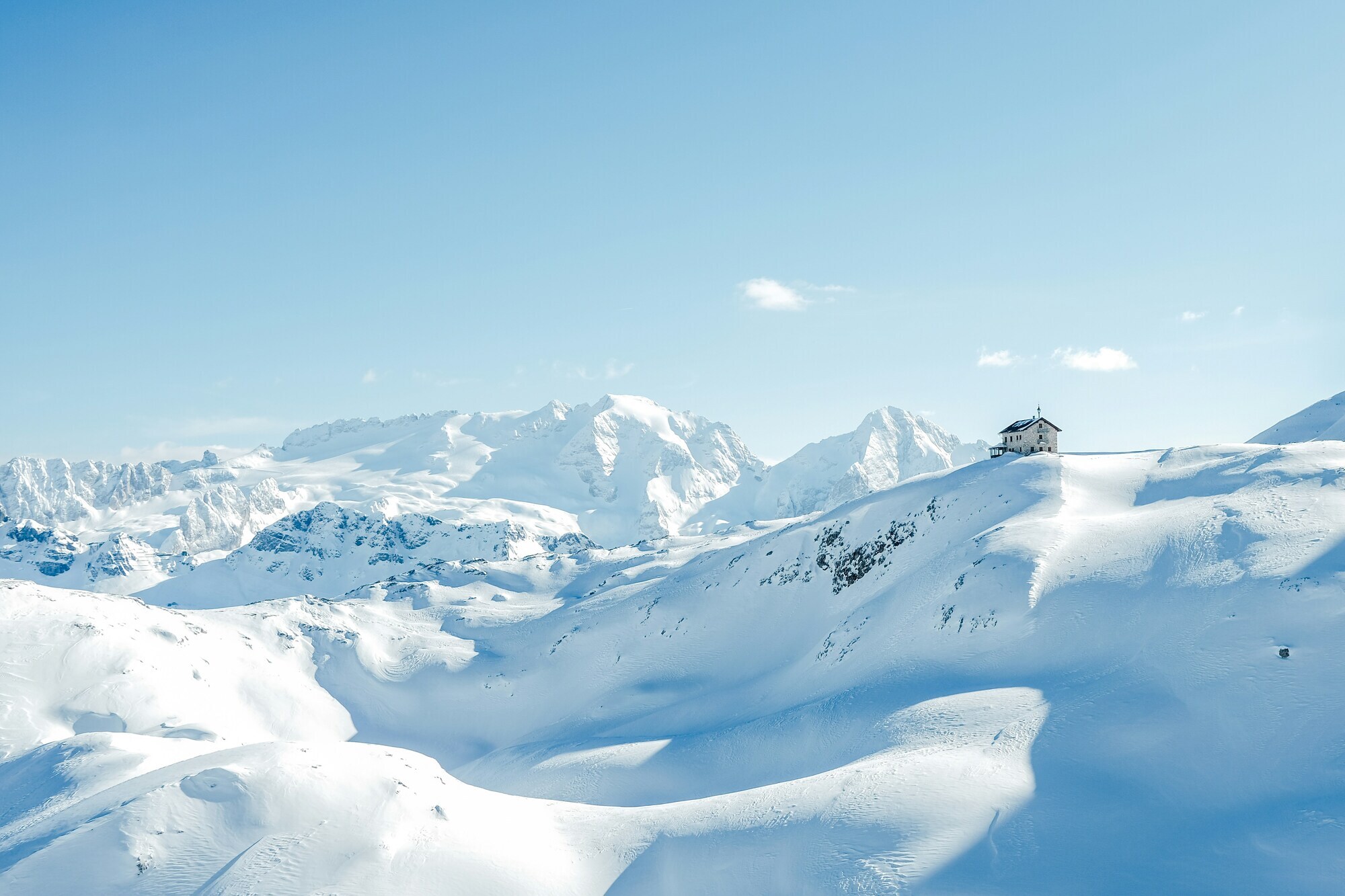 Snow covered mountain landscape and alpine hut